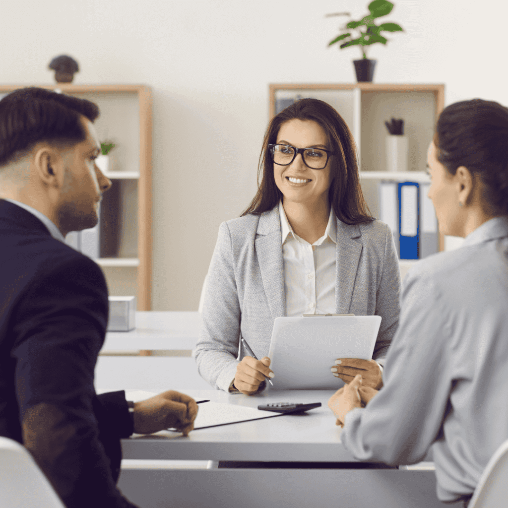 Friendly Insurance Manager or Mortgage Broker Meeting with Clients at Her Office